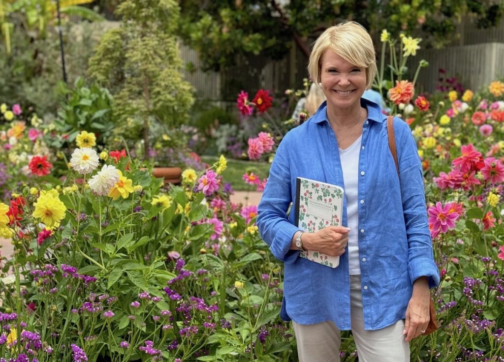 Ellen Bell in garden with flowers | Positive Journal Facilitator