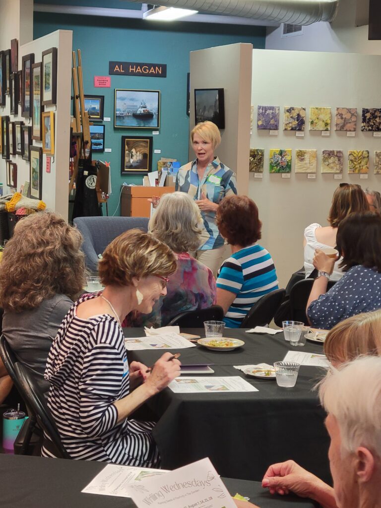 Image of Ellen Bell facilitating reflective journal writing at an arts event | Positive Journal Facilitator