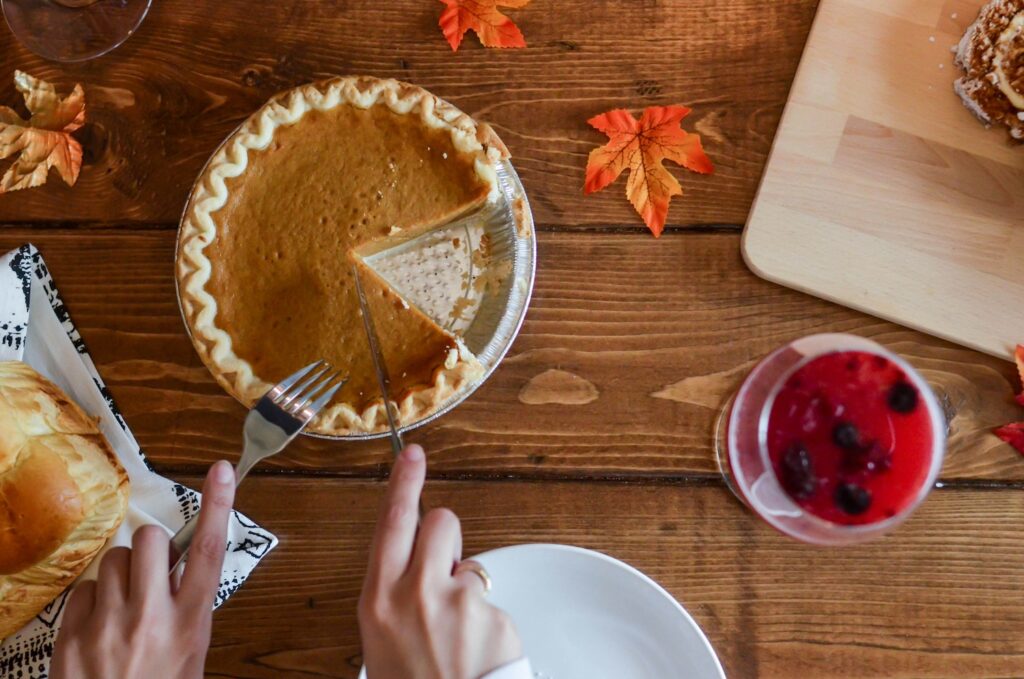 Picture of Pumpkin Pie on Table With Leaves | Holiday Traditions Why They Matter